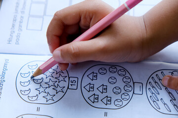 Closeup of schoolboy's hand holding colored pencils