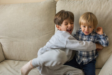 Children Playing On The Sofa.
Stock Photo Of 2 Blond And Caucasian Brothers Playing On The Couch And Laughing. 6 Year Old Boy And 2 Year Old Baby Enjoying The Weekend At Home. Family