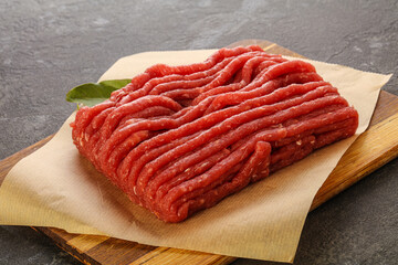 Raw beef minced meat over board