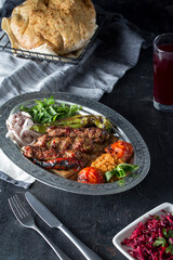 turkish adana kebab, salad, lavash, buttermilk, on the dark bacground