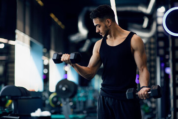 Portrait Of Young Middle Eastern Male Bodybuilder Training With Dumbbells At Gym