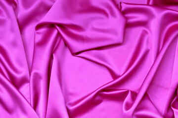 Satin, shiny fabric is folded into graceful folds. A shade of purple. sample for sale