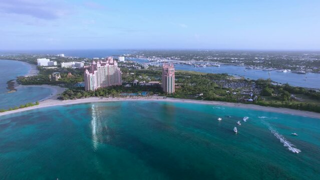 The drone aerial footage of Cove beach of Paradise Island on the background of Nassau city and bridges, Bahamas.