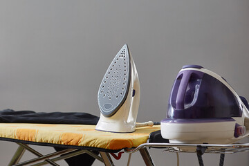 steam generator on the ironing board place for text. - obrazy, fototapety, plakaty
