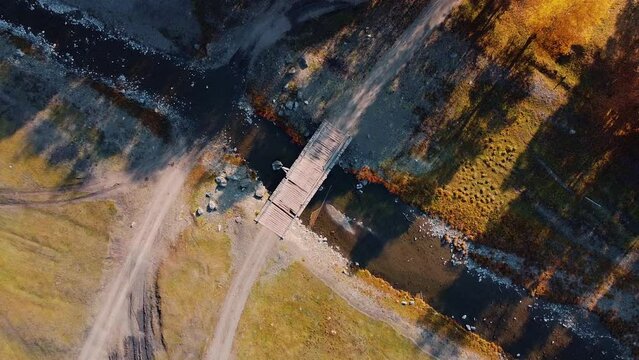 Autumn drone Sunny day in nature with clear river, green and yellow pine and birch trees, bridge and fields