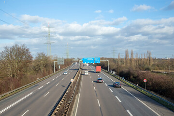 view to german highway A5 with speed reduction to 120 km and blue signage for next exit.