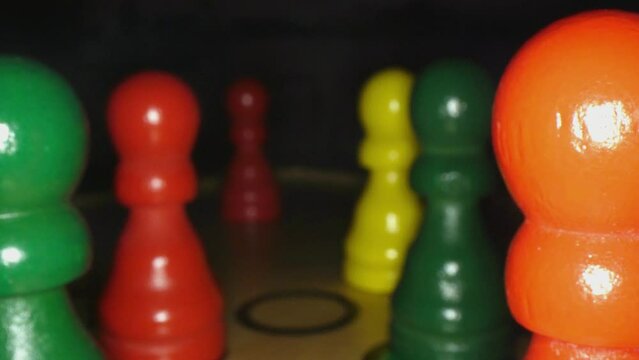 Parcheesi game pieces on a game board in ultra close up, 4k with narrow depth of field