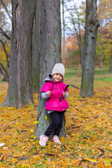 Happy little girl in the park. Autumn season.