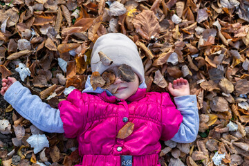 Happy little girl in the park. Autumn season.