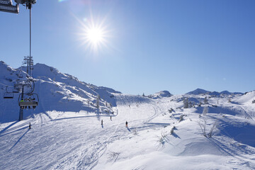skiers rushes down a snowy slope
