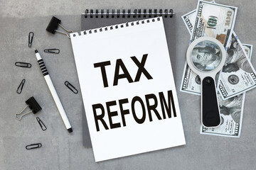 TAX REFORM On the desktop, a gray notepad, reports, a white sheet of paper
