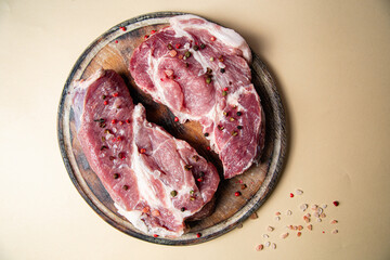 Raw pork steak on a plain background. Raw meat