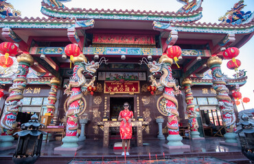 China Girl,Chinese woman red dress traditional cheongsam ,close up portrait with cloth backdrop