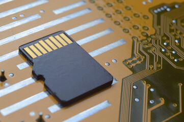 the black micro sd card lies on the microcircuit. close-up.