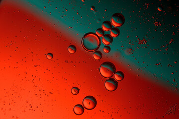 abstract background. drops of oil on water, red and green color. macro