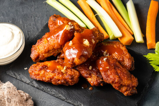 Chicken wings fried bbq. Buffalo chicken wings with vegetables.