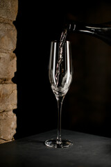Elegant crystal champagne flute filled with sparkling champagne isolated on black background