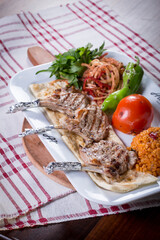 traditional beautifully grilled chopped steaks with bulgur pilaf and side dish