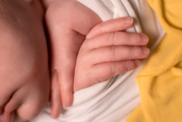 Fototapeta premium concept of love and family. hands of mother and baby closeup