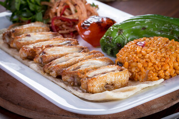 grilled wings with tomato pepper and bulgur pilaf