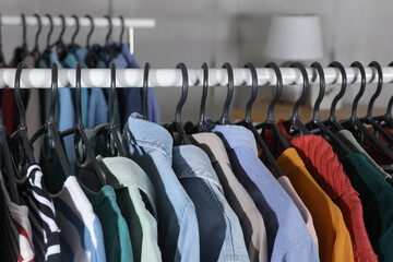 Fototapeta premium Rack with stylish clothes indoors, closeup. Fast fashion