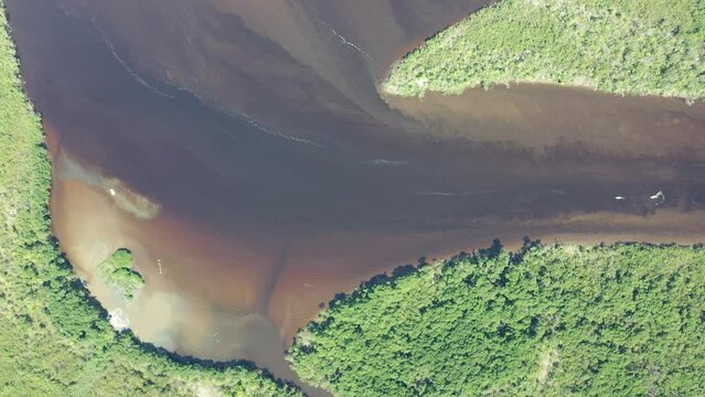 Panning wide view of peaceful darm river at coastal city of Itanhaem Sao Paulo Brazil. South coast of state of Sao Paulo. Tropical scenery. Travel destinations. Popular tourism landmark.