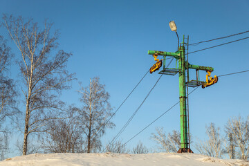 Old abandoned ski lift on the mountain close-up. Winter. Outdoors