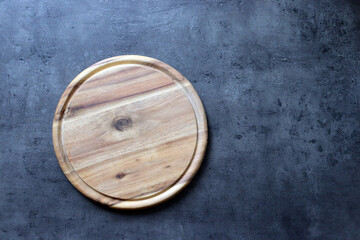 Round wooden board on granite