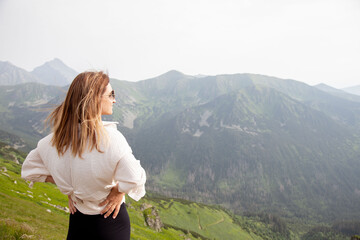 Young woman enjoy view in mountains.