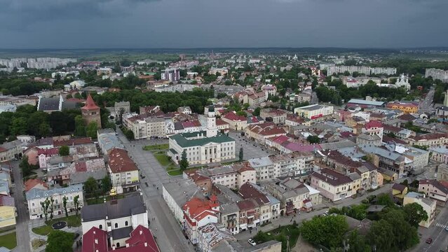 Aerial shot of downtown city hall in historical and cultural center of Drohobych near Lviv West Ukraine in Eastern Europe on summer day before storm. Drone sityscape with mountains and dark clouds.