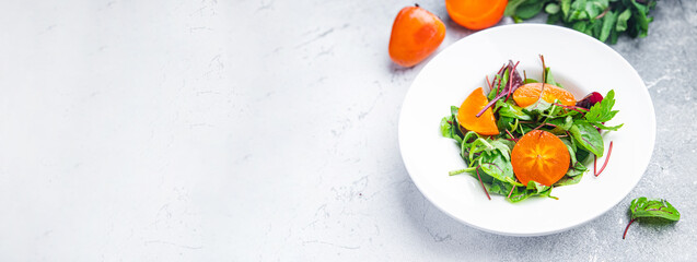 fruit salad persimmon lettuce green leaves mix healthy meal food snack on the table copy space food background keto or paleo diet