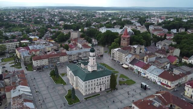 Aerial shot of downtown city hall in historical and cultural center of Drohobych near Lviv West Ukraine in Eastern Europe on summer day before storm. Drone sityscape with mountains and dark clouds.