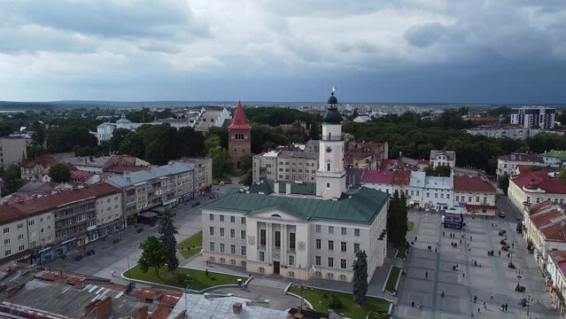 Aerial shot of downtown city hall in historical and cultural center of Drohobych near Lviv West Ukraine in Eastern Europe on summer day before storm. Drone sityscape with mountains and dark clouds.