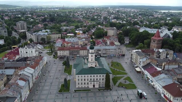 Aerial shot of downtown city hall in historical and cultural center of Drohobych near Lviv West Ukraine in Eastern Europe on summer day before storm. Drone sityscape with mountains and dark clouds.
