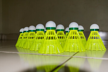 Nylon made yellow color badminton shuttlecock close view looking awesome placed on floor in different position. - 483740751