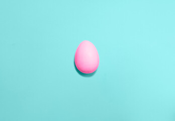 Easter eggs colored with pink color on a blue background. Flat lay. Copy space for text, mock up. Banner. 