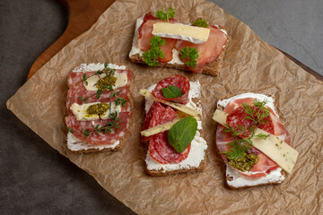 Bruschetta or traditional tapas.  Appetizers, antipasti snacks set on wooden board. Top view with space for your text, copy space