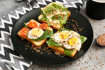 Plate with fresh toasts on grunge background