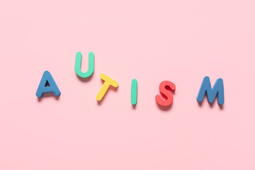 Word AUTISM on pink background