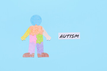 Colorful human figure and word AUTISM on color background
