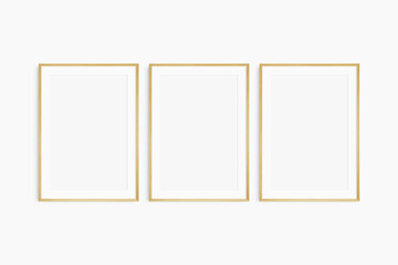 Frame mockup 5x7, 50x70, A4, A3, A2, A1. Set of three thin oak wood frames. Gallery wall mockup, set of 3 frames. Clean, modern, minimalist, bright. Portrait. Vertical. Mat opening 2:3.