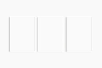 Frame mockup 5x7, 50x70, A4, A3, A2, A1. Set of three thin white frames. Gallery wall mockup, set of 3 frames. Clean, modern, minimalist, bright. Portrait. Vertical.