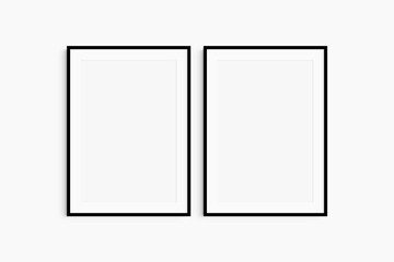 Frame mockup 5x7, 50x70, A4, A3, A2, A1. Set of two thin black frames. Gallery wall mockup, set of 2 frames. Clean, modern, minimalist, bright. Portrait. Vertical. Mat opening 2:3.