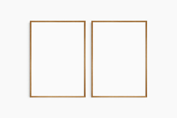 Frame mockup 5x7, 50x70, A4, A3, A2, A1. Set of two thin cherry wood frames. Gallery wall mockup, set of 2 frames. Clean, modern, minimalist, bright. Portrait. Vertical.