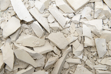 the surface is dotted with splinters and pieces of broken gypsum blocks