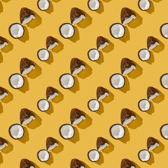 A pattern of coconuts on a bright yellow background.