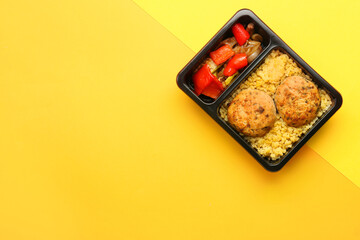 Container with delicious lunch on color background