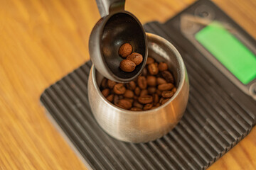 Close up weighing a coffee bean on electronic scales for prepare making a coffee.