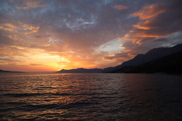 Sunset in the sea. Picturesque cloudy sky and sea at sunset in summer evening. Croatia, Dalmatia, Makarska
