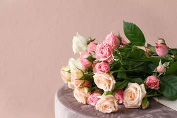 Bouquet of beautiful roses on table